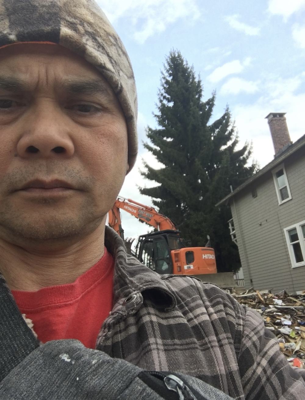 On site during a demolition project with excavator in background
